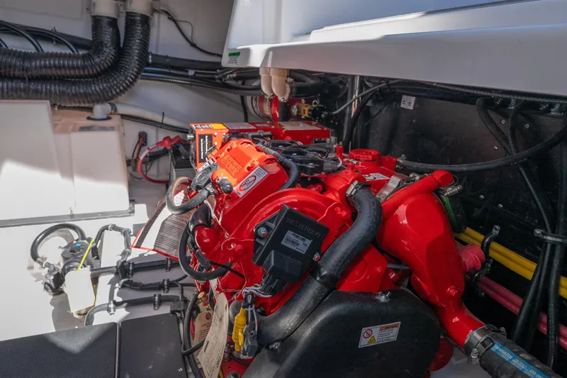 Slide: The Image of Engine compartment of 2026 Monterey 378SS Super Sport boat, featuring vibrant red components. - 48