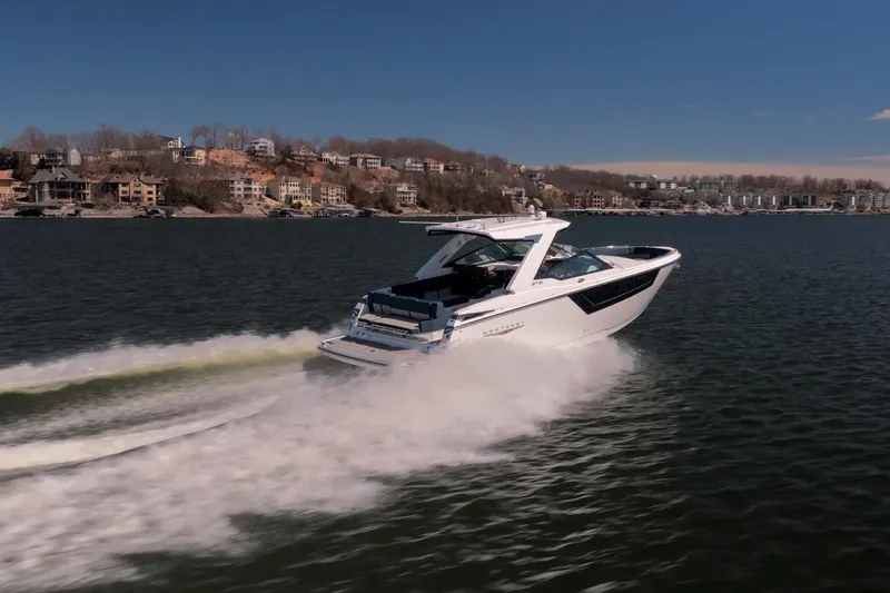 Slide: The Image of 2026 Monterey 378SS Super Sport cruising on a scenic lake with waterfront homes. - 51