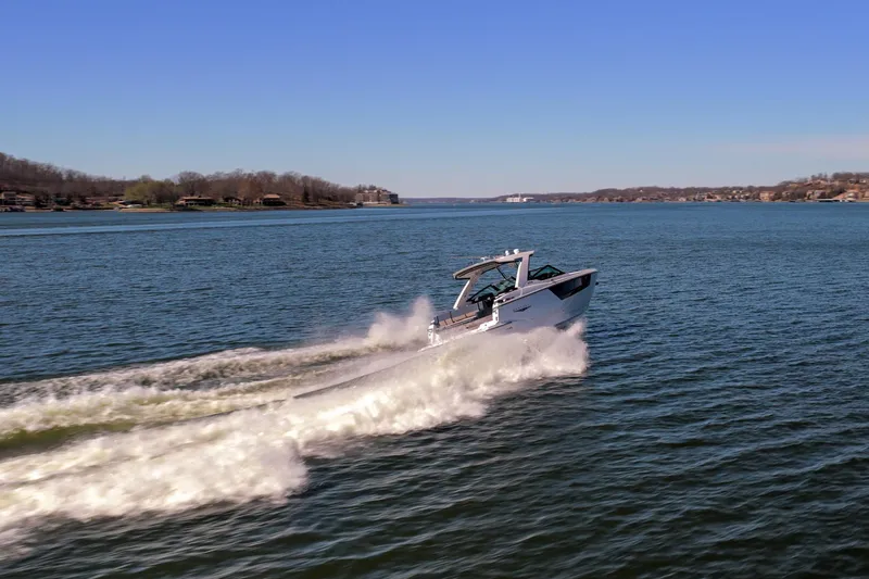 Slide: The Image of 2026 Monterey 378SS Super Sport cruising on a scenic lake under clear blue skies. - 55