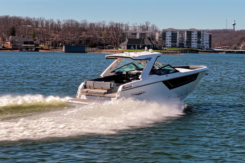 Slide: The Image of 2026 Monterey 378SS Super Sport cruising on a lake with scenic shoreline views. - 56