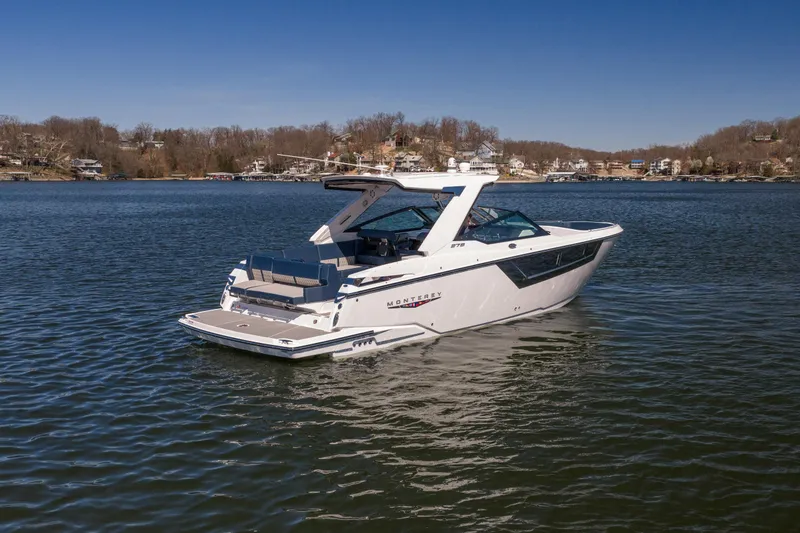 Slide: The Image of 2026 Monterey 378SS Super Sport boat on a serene lake with scenic background. - 59