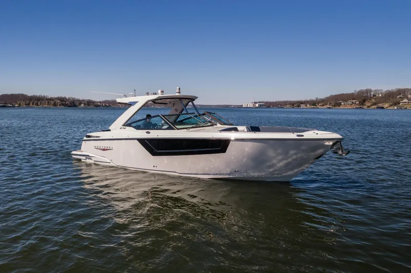 Slide: The Image of 2026 Monterey 378SS Super Sport boat on a calm lake under clear blue skies. - 60