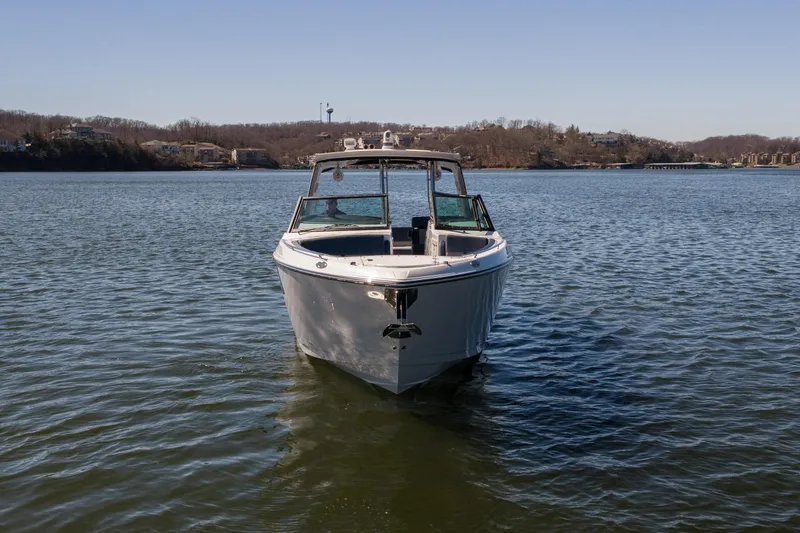Slide: The Image of 2026 Monterey 378SS Super Sport boat on a calm lake under clear skies. - 61