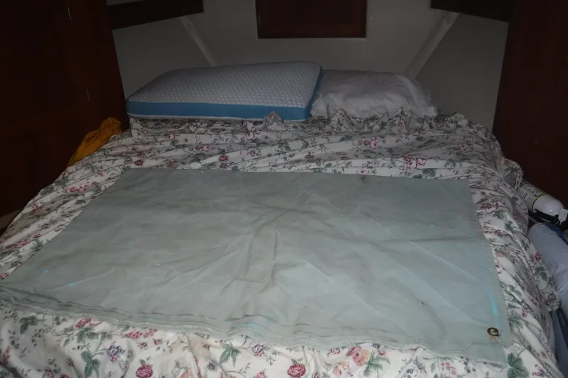 Slide: The Image of Cozy cabin bed with floral bedding in a 2002 Nordic Tug 37 boat. - 14
