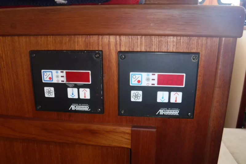 Slide: The Image of Control panels on a 2002 Nordic Tug 37 boat, featuring temperature and fan settings. - 18