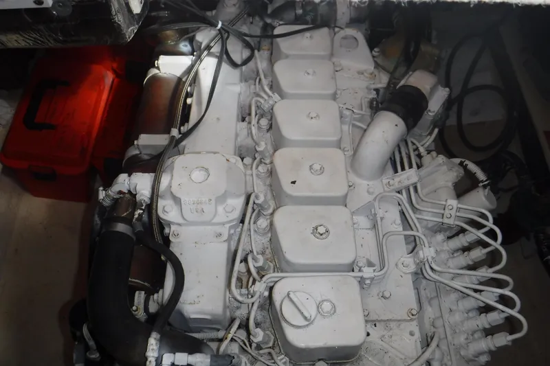 Slide: The Image of Engine compartment of a 2002 Nordic Tug 37, showcasing mechanical components and wiring. - 23