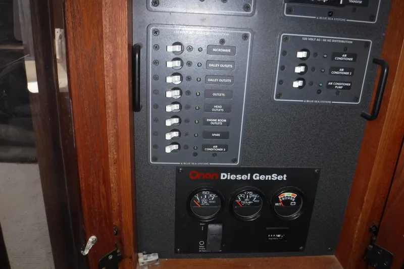 Slide: The Image of Electrical panel and Onan Diesel GenSet controls on a 2002 Nordic Tug 37 boat. - 25