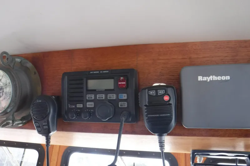 Slide: The Image of Boat navigation equipment on a 2002 Nordic Tug 37, featuring Icom and Raytheon devices. - 30