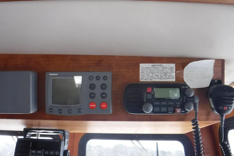 Slide: The Image of Control panel of a 2002 Nordic Tug 37 with navigation and communication equipment. - 31