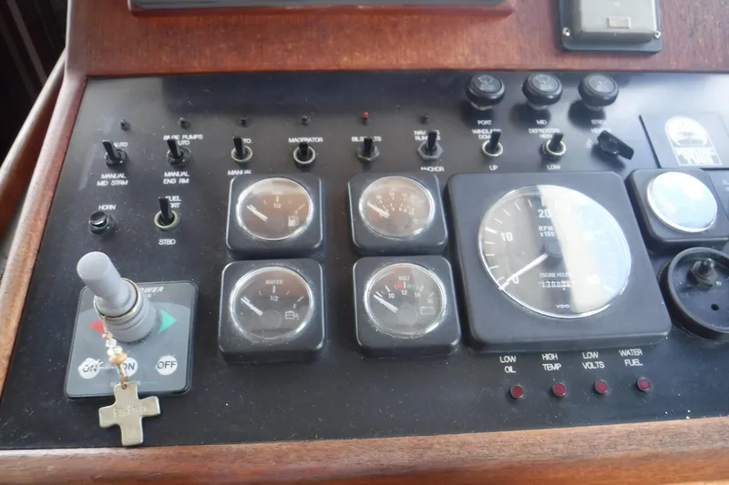 Slide: The Image of Control panel of a 2002 Nordic Tug 37 boat with gauges and switches. - 32