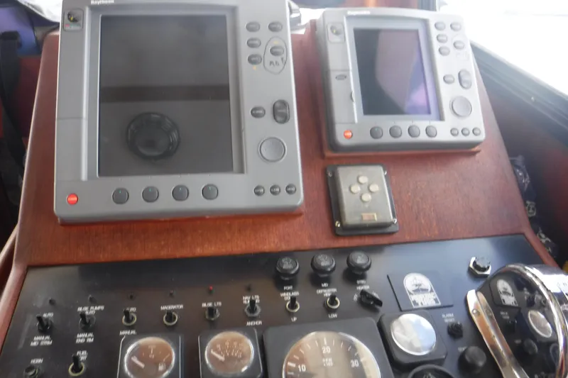 Slide: The Image of Control panel of a 2002 Nordic Tug 37 with navigation instruments and gauges. - 33