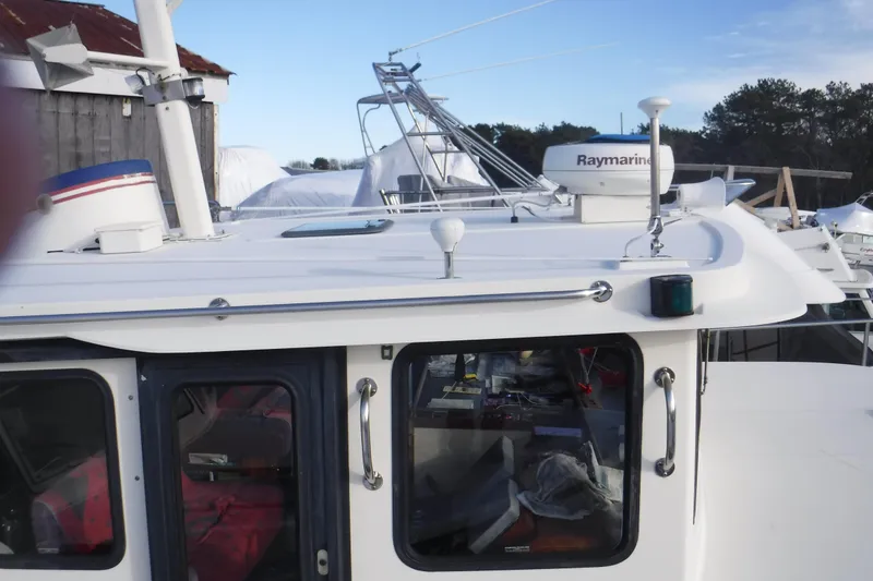 Slide: The Image of 2002 Nordic Tug 37 boat with Raymarine equipment on deck, docked outdoors. - 9