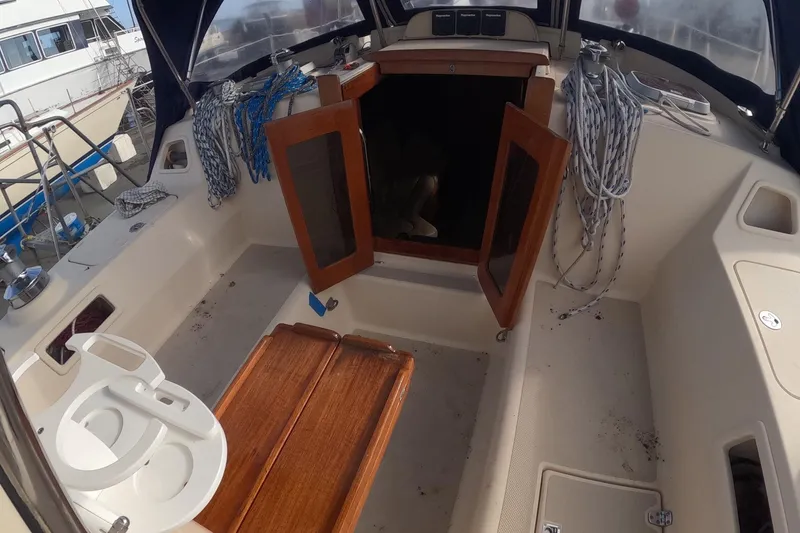 Slide: The Image of 2005 Island Packet 370 sailboat cockpit with open wooden doors and coiled ropes. - 26
