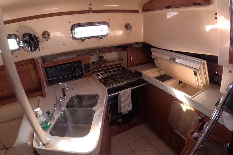 Slide: The Image of 2005 Island Packet 370 yacht kitchen with sink, stove, and storage. - 12