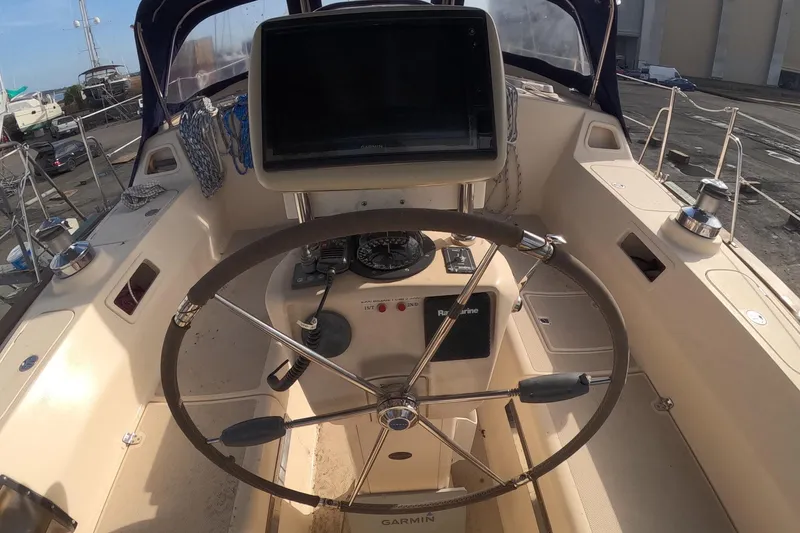 Slide: The Image of Cockpit of 2005 Island Packet 370 sailboat with steering wheel and navigation equipment. - 23