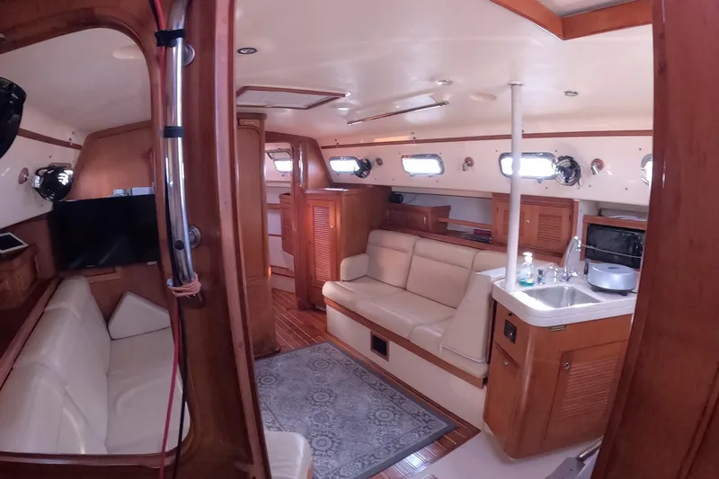 Slide: The Image of Interior of 2005 Island Packet 370 sailboat with cozy seating and kitchenette. - 3