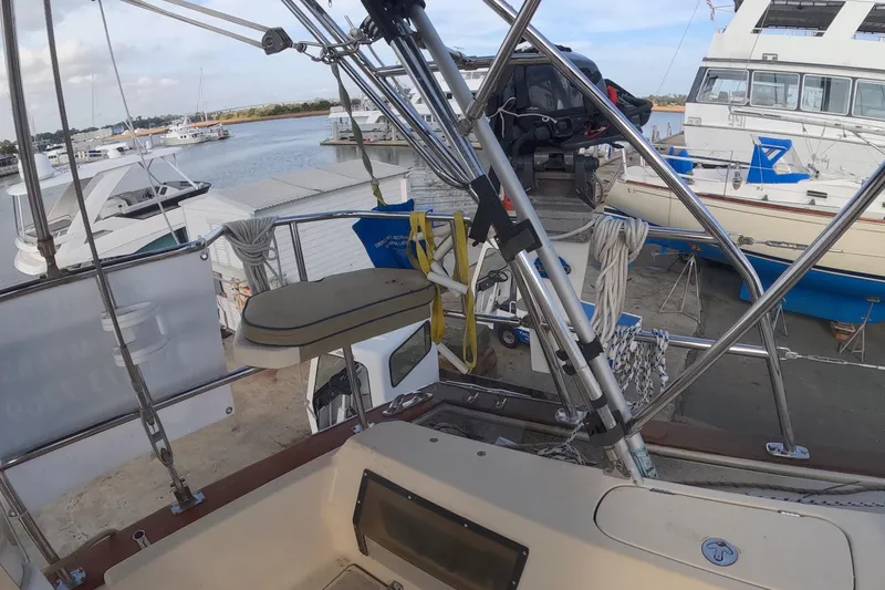 Slide: The Image of 2005 Island Packet 370 sailboat docked, featuring deck equipment and nearby boats. - 21