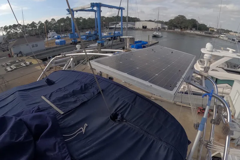 Slide: The Image of 2005 Island Packet 370 sailboat with solar panel at marina dock. - 27