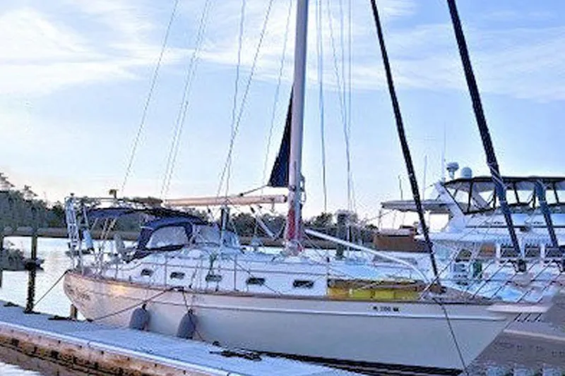 Slide: The Image of 2005 Island Packet 370 sailboat docked at marina under clear sky. - 43