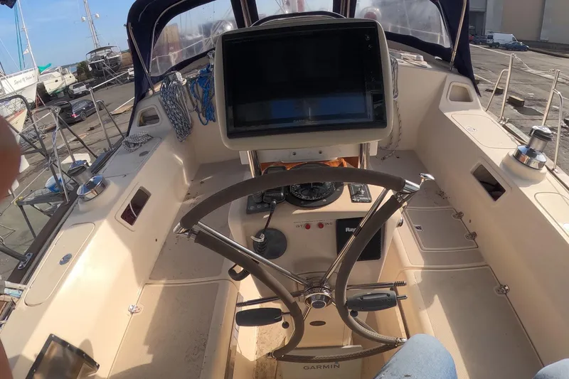 Slide: The Image of Cockpit of 2005 Island Packet 370 sailboat with steering wheel and navigation equipment. - 22