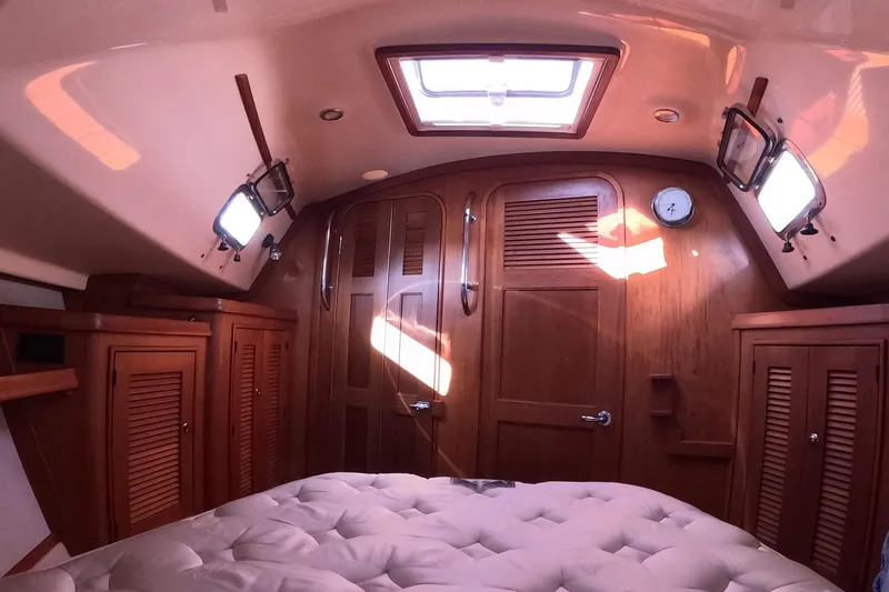 Slide: The Image of Cozy cabin interior of 2005 Island Packet 370 sailboat with wooden finishes and natural light. - 8