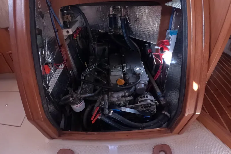 Slide: The Image of Engine compartment of a 2005 Island Packet 370 sailboat, showcasing mechanical components. - 16