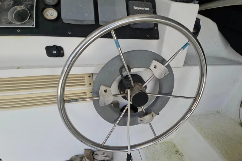 Slide: The Image of Steering wheel of a 2005 Gemini MC 105 boat with navigation instruments. - 10