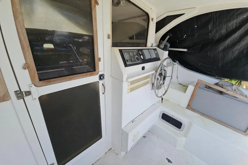 Slide: The Image of Interior view of a 2005 Gemini MC 105 boat cockpit with steering wheel and control panel. - 11