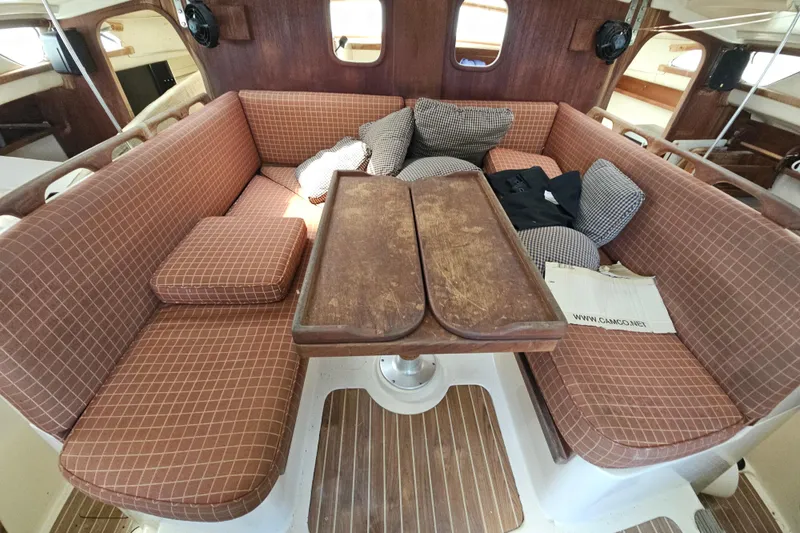 Slide: The Image of Cozy interior of 2005 Gemini MC 105 sailboat with cushioned seating and wooden table. - 16