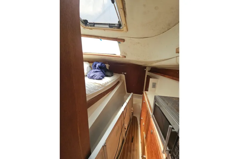 Slide: The Image of Interior of 2005 Gemini MC 105 sailboat with cozy cabin and wooden cabinetry. - 19