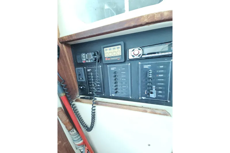 Slide: The Image of Control panel of a 2005 Gemini MC 105 boat with various switches and devices. - 25