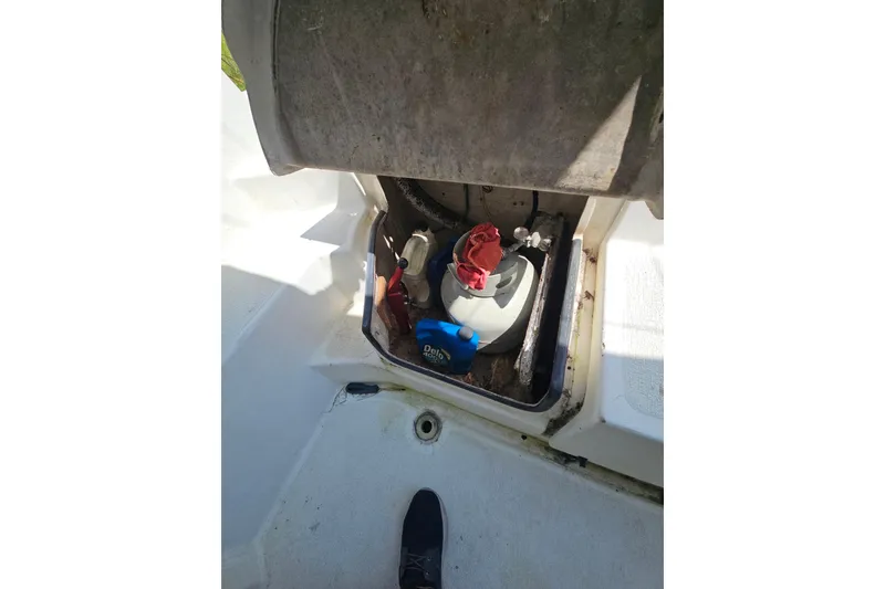 Slide: The Image of Open storage compartment on 2005 Gemini MC 105 boat, showing equipment and supplies. - 28