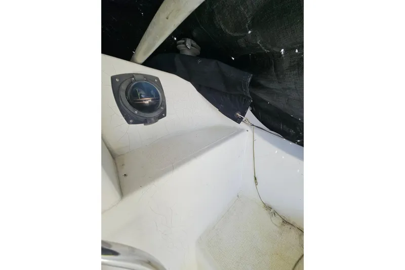 Slide: The Image of Interior view of a 2005 Gemini MC 105 boat, featuring a compass and seating area. - 31