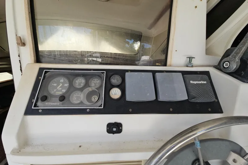 Slide: The Image of Control panel of a 2005 Gemini MC 105 boat with gauges and Raymarine equipment. - 9