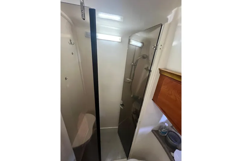 Slide: The Image of Bathroom interior of 2008 Rinker 400 Express Cruiser with shower and storage. - 17