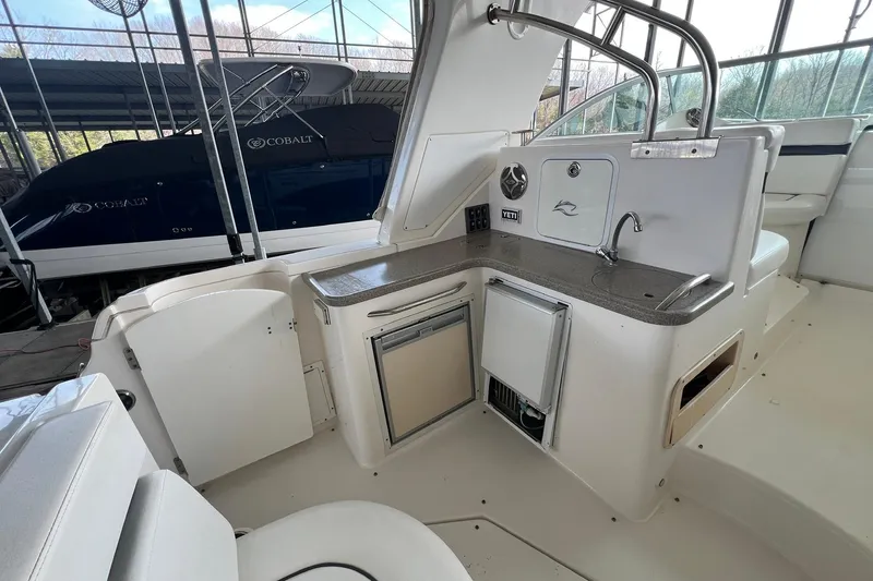 Slide: The Image of 2008 Rinker 400 Express Cruiser interior with kitchenette and seating area. - 4
