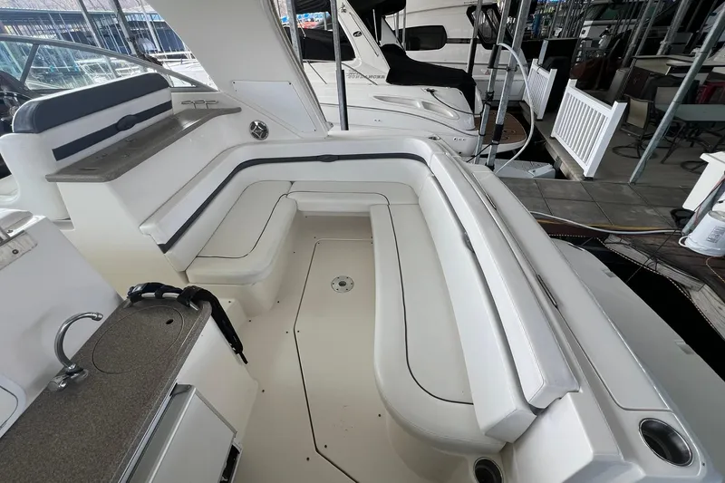 Slide: The Image of 2008 Rinker 400 Express Cruiser interior with white seating and compact kitchenette. - 5