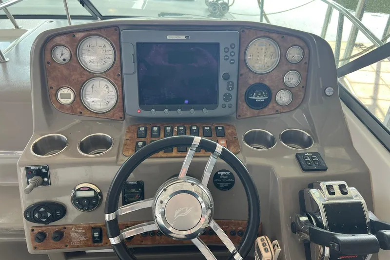 Slide: The Image of 2008 Rinker 400 Express Cruiser helm with gauges, controls, and steering wheel. - 7