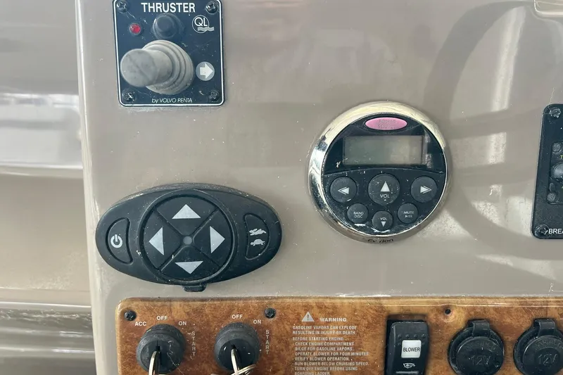 Slide: The Image of Control panel of a 2008 Rinker 400 Express Cruiser with thruster and audio controls. - 8