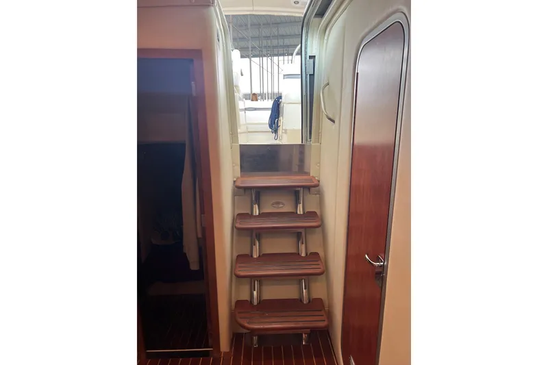 Slide: The Image of Interior view of 2008 Rinker 400 Express Cruiser with wooden stairs and door. - 9
