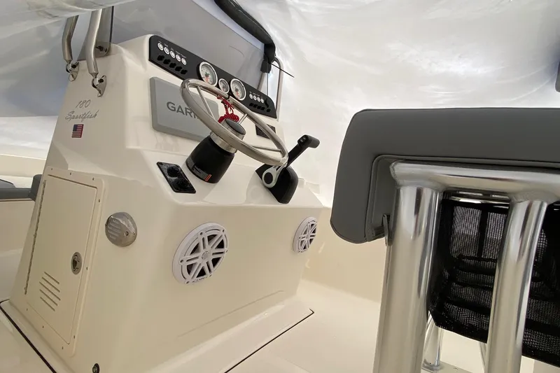 Slide: The Image of 2026 Pioneer 180 Sportfish boat interior with steering wheel and control panel. - 11