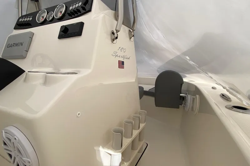 Slide: The Image of 2026 Pioneer 180 Sportfish boat interior with Garmin equipment and rod holders. - 9