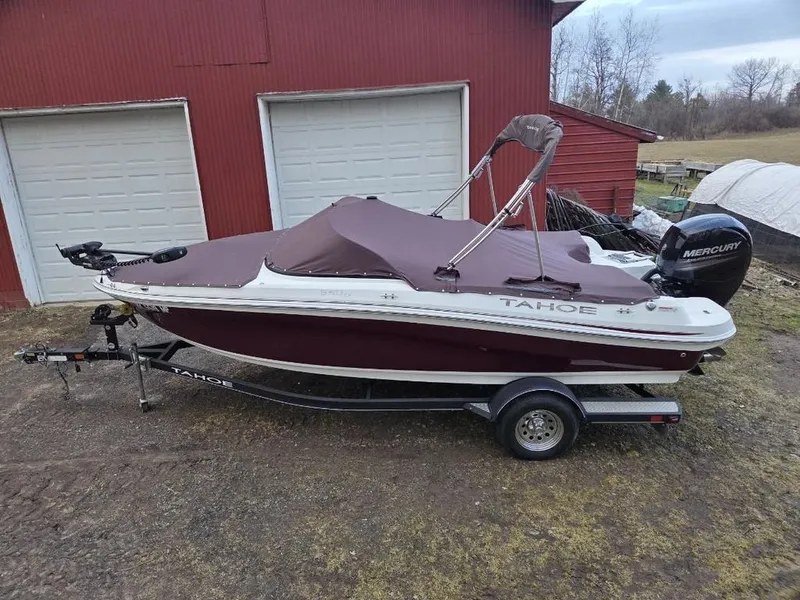 Slide: The Image of 2019 Tahoe 550 TF boat with cover on trailer. - 2