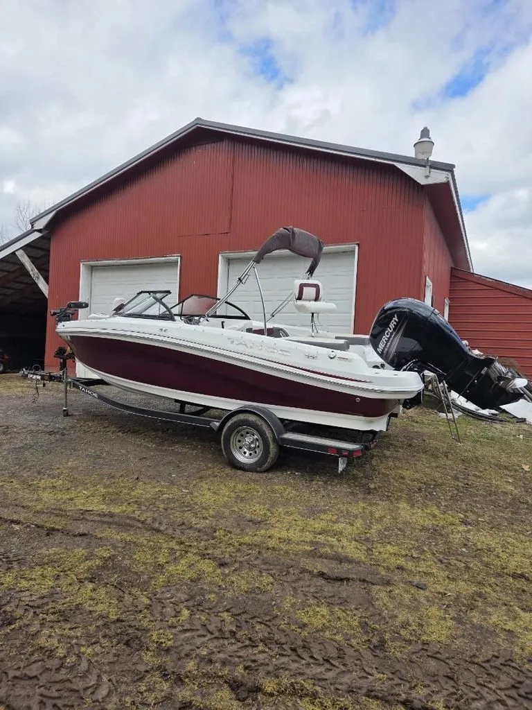 Slide: The Image of 2019 Tahoe 550 TF boat parked in front of red building. - 3