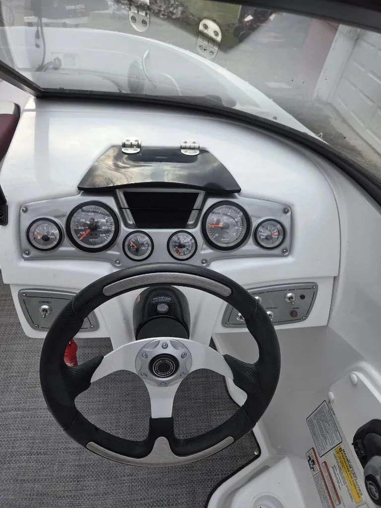Slide: The Image of Dashboard of a 2019 Tahoe 550 TF boat with steering wheel and gauges. - 4