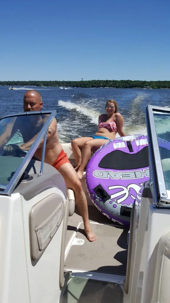 Slide: The Image of People on a Tahoe 500 TS boat with a tube on the water. - 2