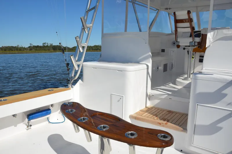 Slide: The Image of 2006 Custom Carolina Heritage Express boat interior with fishing rod holders and seating. - 15