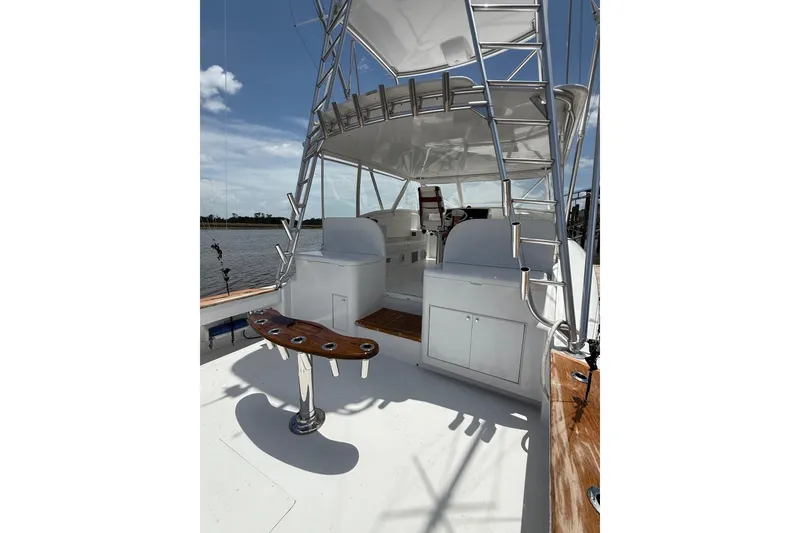 Slide: The Image of 2006 Custom Carolina Heritage Express boat with tower, rod holders, and helm station on deck. - 18
