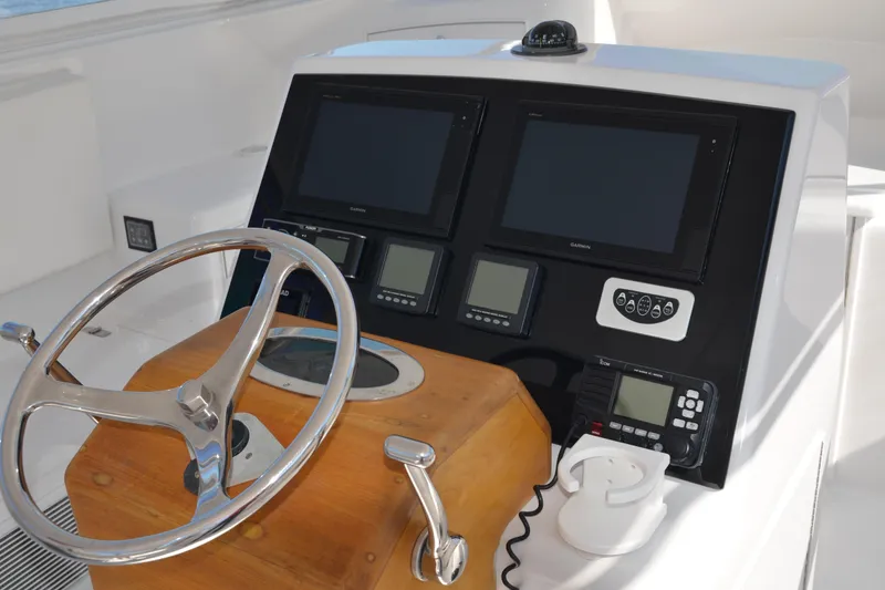 Slide: The Image of Helm of 2006 Custom Carolina Heritage Express boat with navigation screens and controls. - 3