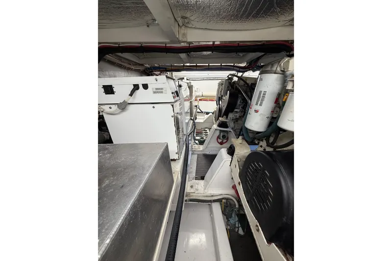 Slide: The Image of Engine room of 2006 Custom Carolina Heritage Express boat, showcasing machinery and components. - 34